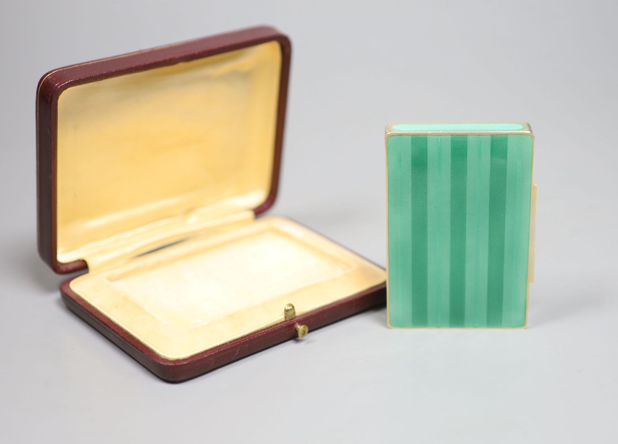 A cased early 20th century Austrian? gilt sterling and green enamelled silver gilt rectangular snuff box, 80mm, gross 122 grams,